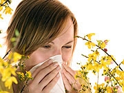 Picture of a hayfever sufferer with flowers all around